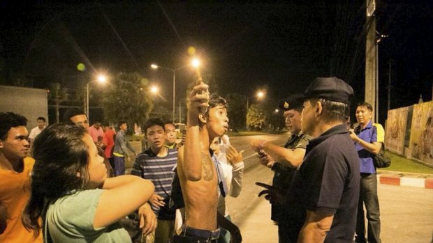 A youth argues with security forces personnel after the unrest in Phuket.