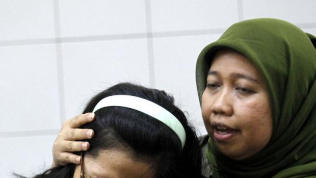 A relative of a passenger of the Sukhoi Superjet 100 aircraft cries at Halim Perdana Kusuma Airport in Jakarta.