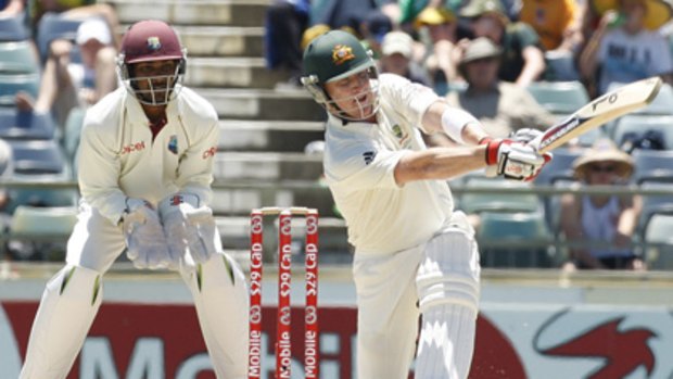 West Indies wicketkeeper Denesh Ramdin (left) looks on as Brad Haddin opens his shoulders during his dashing knock in the first innings of the Third Test at the WACA ground in Perth.