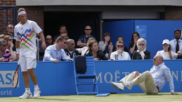 Nalbandian looks on after causing an injury to the line judge in the Queen's Club final in London.