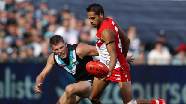 Lewis Jetta of the Swans evades Brad Ebert of the Power yesterday.