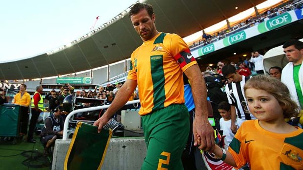 Socceroos captain Lucas Neill leads his team onto the field in November, 2013.