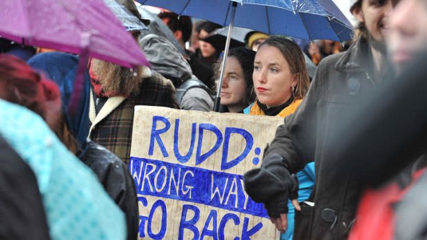 A protester holds a placard during a protest in Melbourne against the government's asylum seeker policy.