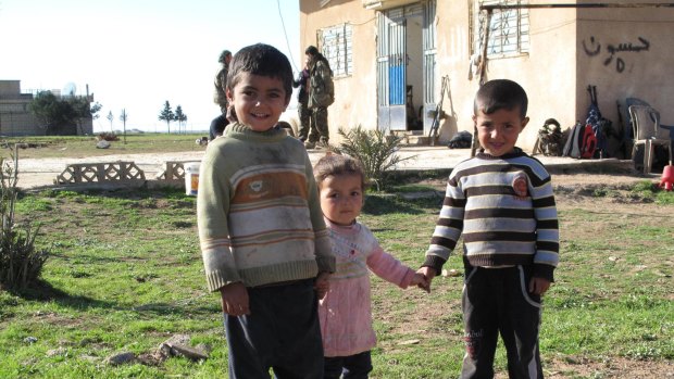 Children on a farm recently freed from Islamic State control.
