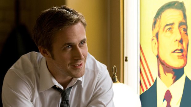 Gosling with Clooney as a poster, one of his many roles on <i>Ides of March</i>.