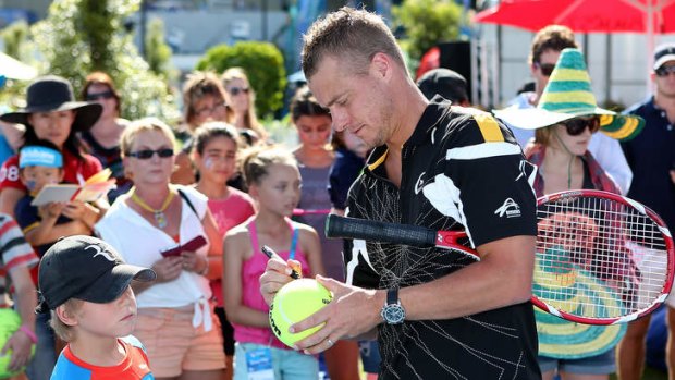 A relaxed Lleyton Hewitt signing autographs on day two of the Brisbane International at Pat Rafter Arena.