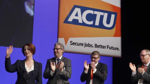 Tale of humility ... Julia Gillard with the newly-elected secretary of the ACTU, Dave Oliver, speaks at the congress in Sydney.