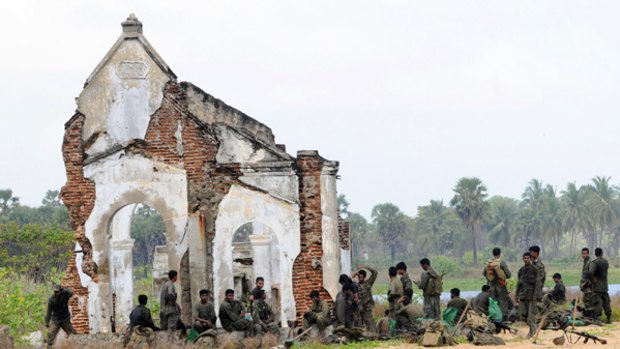 Sri Lankan soldiers beside the destroyed former headquarters of the Tamil Tigers in Mullaittivu.