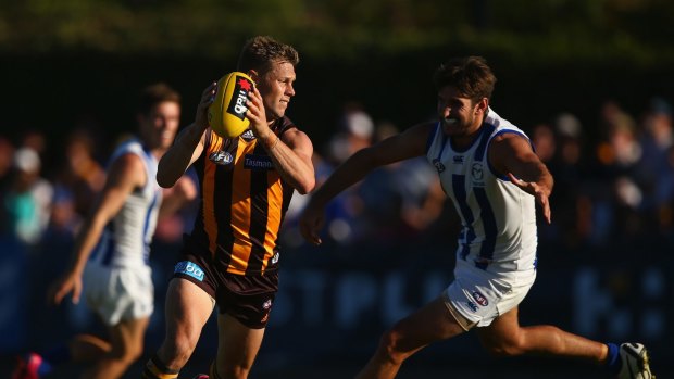On the run: Sam Mitchell looks to evade a tackle in Hawthorn’s clash with North Melbourne on Sunday. 