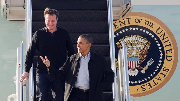 Barack Obama and David Cameron step off Air Force One.