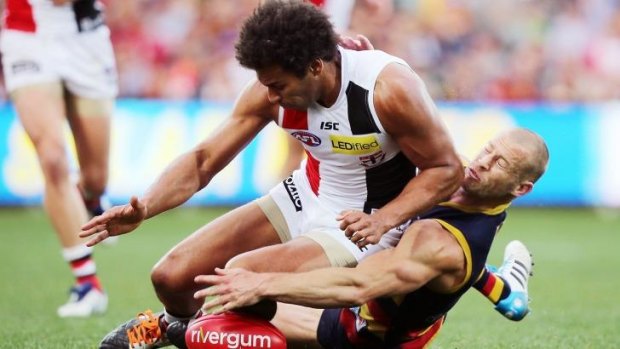 James Gwilt of the Saints competes for the ball with Scott Thompson of the Crows.