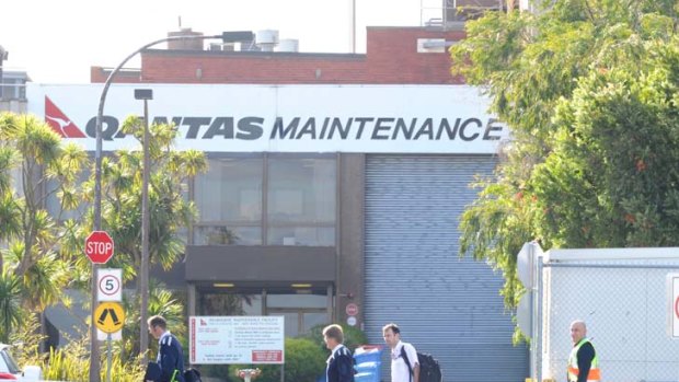 Latest employees to become statistics ... Qantas engineers leaving the maintenance plant yesterday.