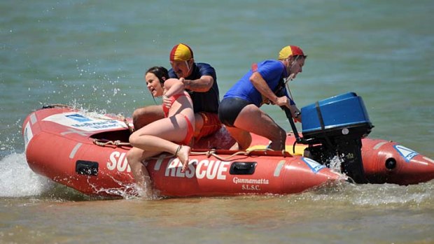 Gunnamatta lifesavers Geoff Tobias and Ray Webb pull a teenage girl to safety after she got into trouble at the Mornington Peninsula beach.