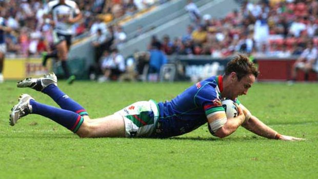One of a trio ... James Maloney scores a try for the Warriors against the Brisbane Broncos at Suncorp Stadium  yesterday. Maloney crossed for three tries and booted eight goals for a personal tally of 28 points, matching his club’s record.