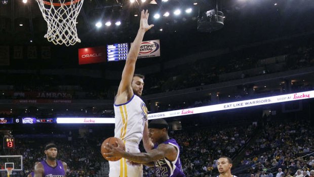 Golden State Warriors centre Andrew Bogut plays tough defence against Sacramento in their NBA pre-season clash.