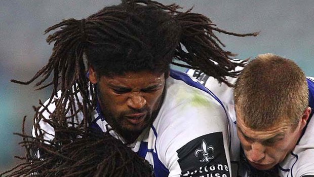 Hair raising . . .  Lote Tuqiri of the Tigers tackled by Jamal Idris in the round one clash against the Bulldogs.