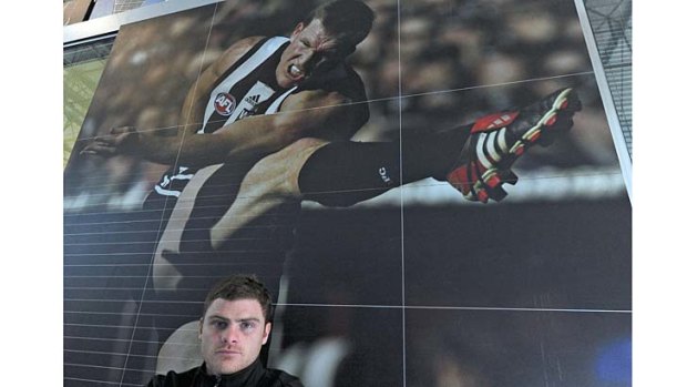 Magpie great: Heath Shaw stands before a picture of Nathan Buckley.