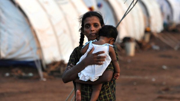 A displaced Tamil woman holds her baby at a camp in the northern Sri Lankan district of Vavuniya earlier this month.