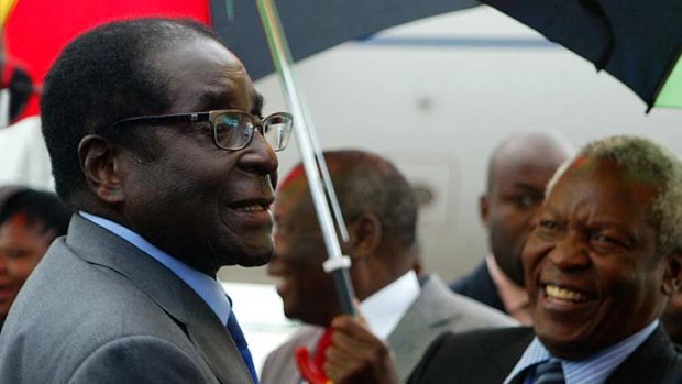 Robert Mugabe arrives home in Zimbabwe as officials brushed aside reports that he is gravely ill.