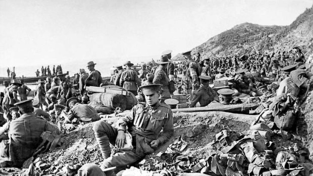 Australian soldiers rest amongst others killed and wounded on the beach at Anzac Cove on the day of the landing.
