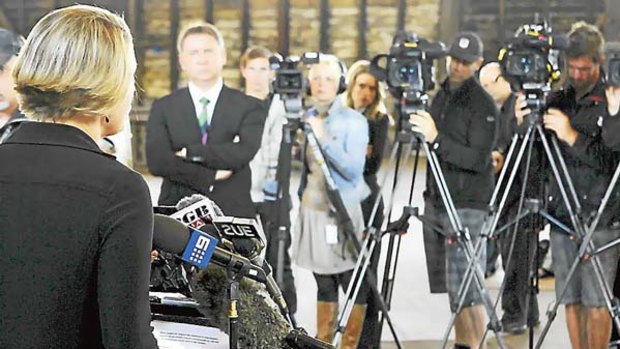 Brave face... Kristina Keneally addresses the media after a resignation.