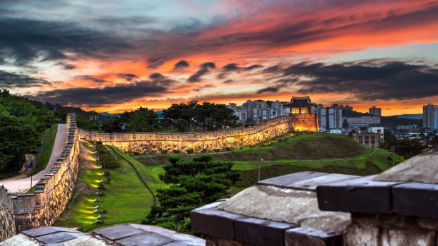 Hwaseong Fortress resembles a Great Wall of China in miniature, running six kilometres up and down hills and enclosing an old town and pine-scented forest. 