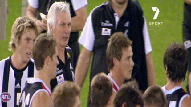 Mick Malthouse appears to speak to Stephen Milne (far right) at quarter time during the Magpies' clash with St Kilda.