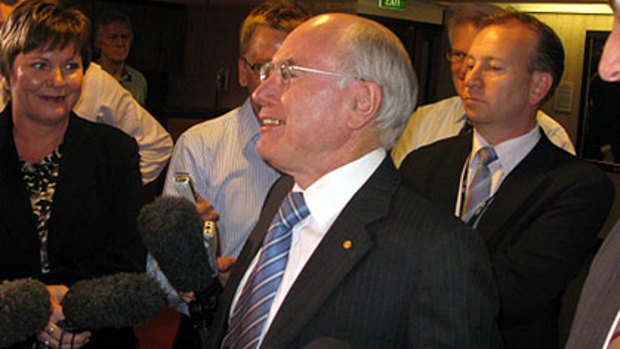 Centre of attention ... former Prime Minister John Howard speaks to the media during his visit to Brisbane today.