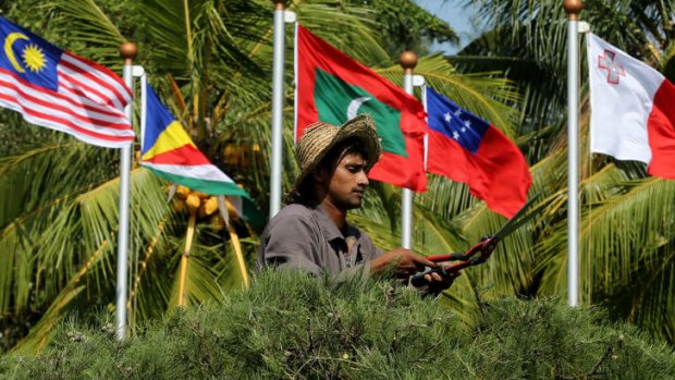 True colours: A gardener trims a hedge outside the summit venue as Sri Lanka prepares to host the Commonwealth Heads of Government Meeting.