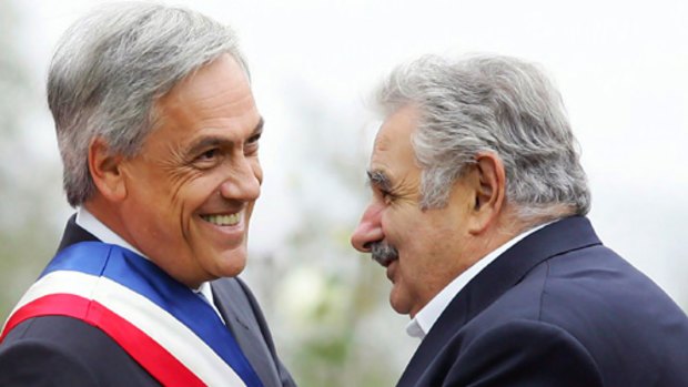 Chilean President Sebastian Pinera, left, shakes hands with Uruguayan President Jose Mujica.