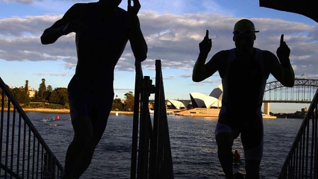 Room to roam ...  competitors emerge from Sydney  Harbour during the first leg of the triathlon early yesterday.