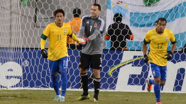 Red-faced ... Brazil's Neymar (11) is comforted by Colombia's keeper David Ospina.