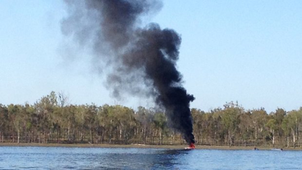 Mother and baby escape from burning boat at dam west of Brisbane.