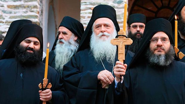 Chaps in black... monks gather at a monastery on Mount Athos.