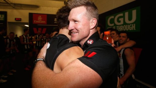 A beaming Nathan Buckley embraces Brent Macaffer after the game on Sunday.