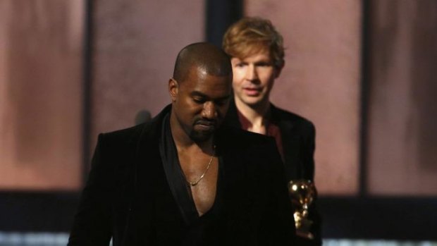 Beck watches Kanye West, who pretended to take the stage after Beck won album of the year at the Grammys.