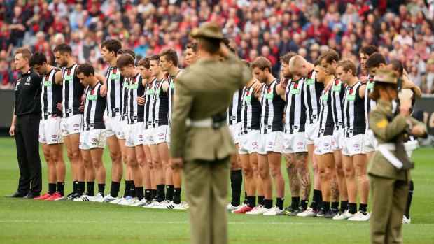 MELBOURNE, AUSTRALIA - APRIL 25:  Magpies players stand for the Anzac Day Ceremony during the round four AFL match between the Essendon Bombers and the Collingwood Magpies at Melbourne Cricket Ground on April 25, 2015 in Melbourne, Australia.  (Photo by Quinn Rooney/Getty Images)
