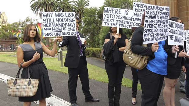 Showing support: Simon Gittany's partner Rachelle Louise, left, holds a sign outside court with other protesters.