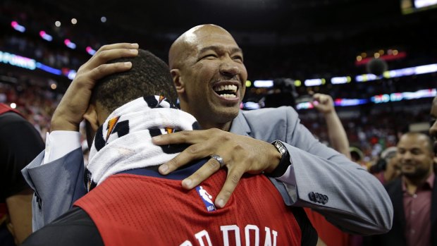Jubilation: New Orleans head coach Monty Williams celebrates with guard Eric Gordon after their victory over the San Antonio Spurs. The Pelicans won 108-103 to lock up the final playoff slot in the Western Conference.