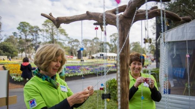 Remembering: RSPCA volunteers Sue Jose and Judy Nowland at Floriade putting pets tags a memorial tree for people whose pets have died.