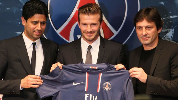 Bonjour: David Beckham is all smiles at a media conference in Paris after signing with Paris St-Germain.