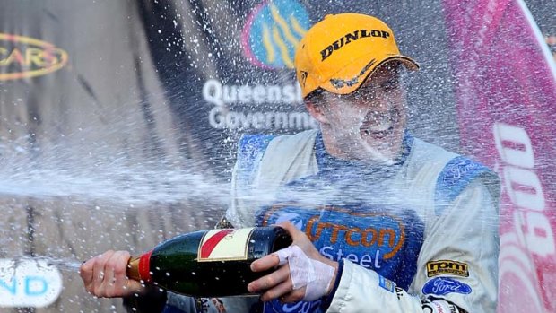Gold Coast win ... Mark Winterbottom celebrates after his V8 win.