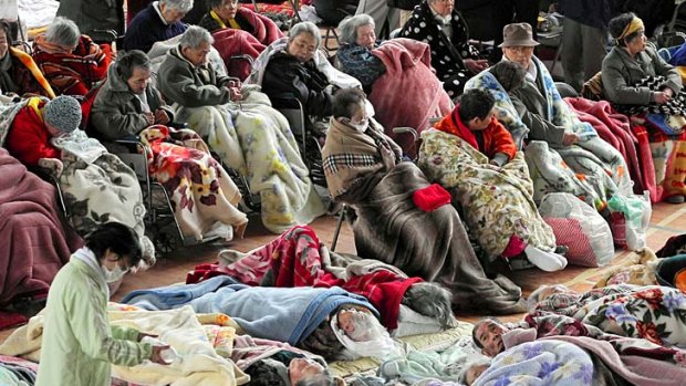 Cold and homeless ...  residents of a home for the elderly in Kesennuma sit in a shelter, rugging up against temperatures in the disaster zone that have dropped below freezing.
