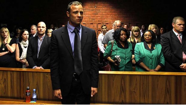 Dark days ... Oscar Pistorius awaits the start of court proceedings in the Pretoria Magistrates court.
