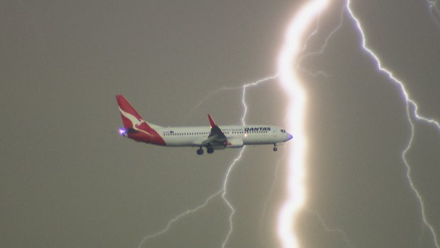 Lightning flashes behind a Qantas plane, as captured from La Perouse on Tuesday evening.
