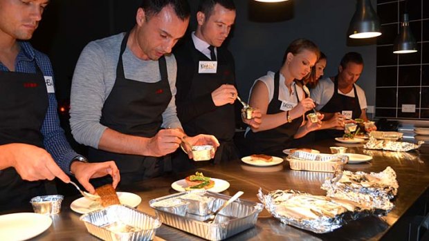 Plating up ... Virgin Australia flight attendants learn how to serve items from Luke Mangan's in-flight menu at the celebrity chef's new Sydney wine bar, Mojo.