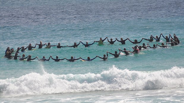 Surfers remember Kyle in an emotional paddle-out at Bunker Bay.