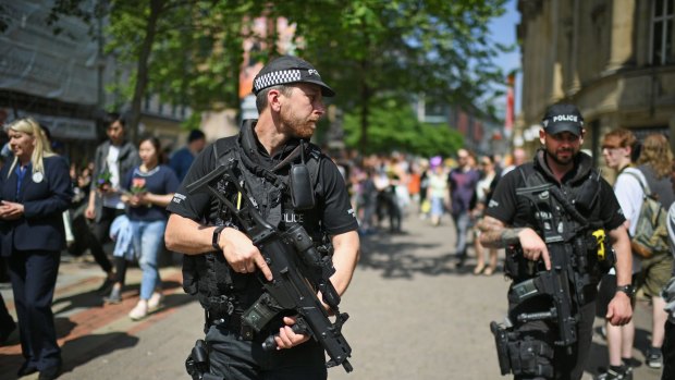 Armed police patrol in Manchester, England. 