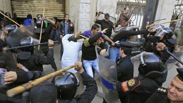 Showdown ...  riot police clash with protesters in Cairo on Wednesday. At least six people have been killed and dozens injured in three days of protests.