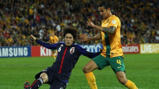 Tim Cahill of Australia is challenged  during the FIFA World Cup Asian Qualifier match between the Australian Socceroos and Japan at Suncorp Stadium.